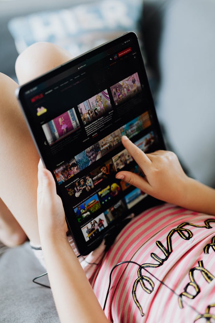 about-img-01 Young girl using a digital tablet indoors, browsing media content during leisure time.